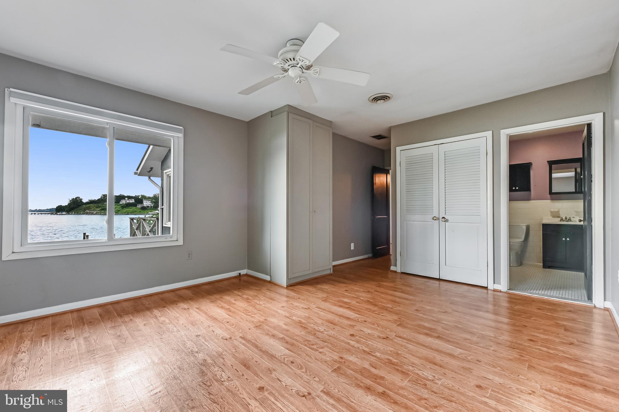 769 Robin Hood Road Annapolis, MD 21405 - Photo 42 of 79 a view of an empty room with a window and wooden floor