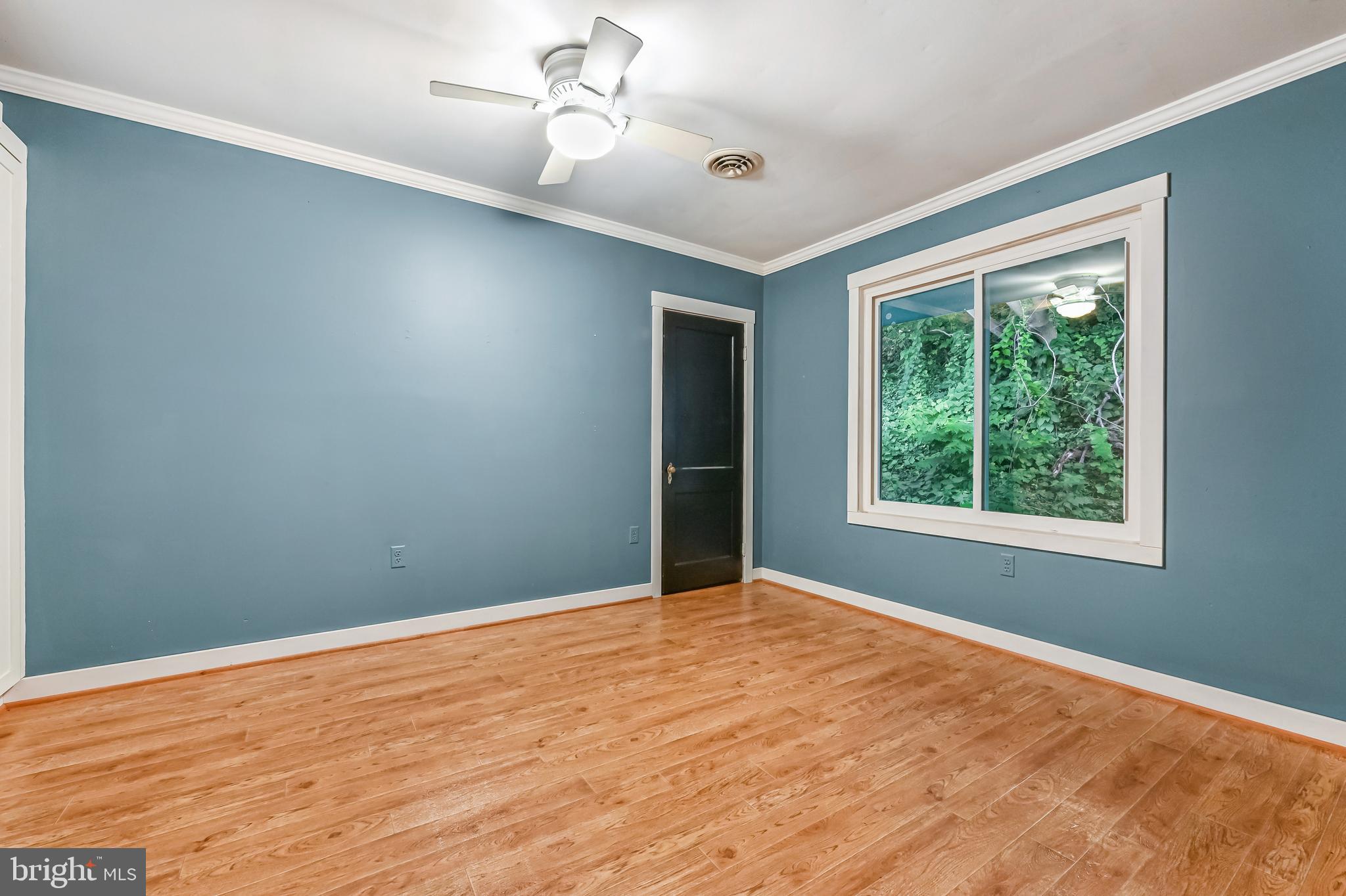 769 Robin Hood Road Annapolis, MD 21405 - Photo 44 of 79 a view of an empty room with wooden floor and a window