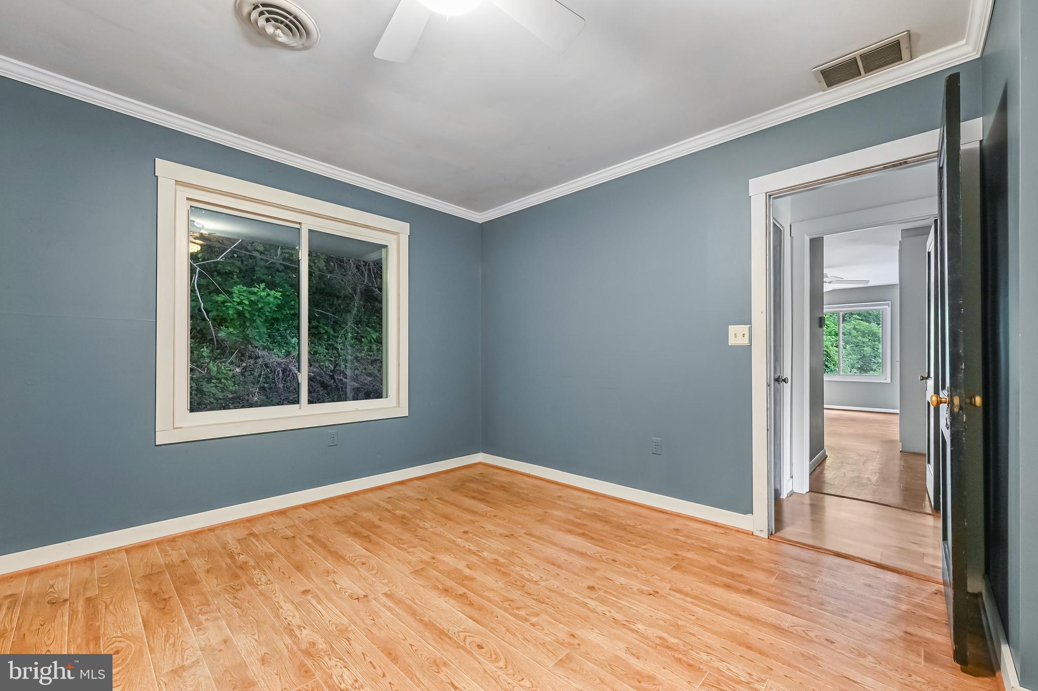 769 Robin Hood Road Annapolis, MD 21405 - Photo 45 of 79 a view of an empty room with wooden floor and a window