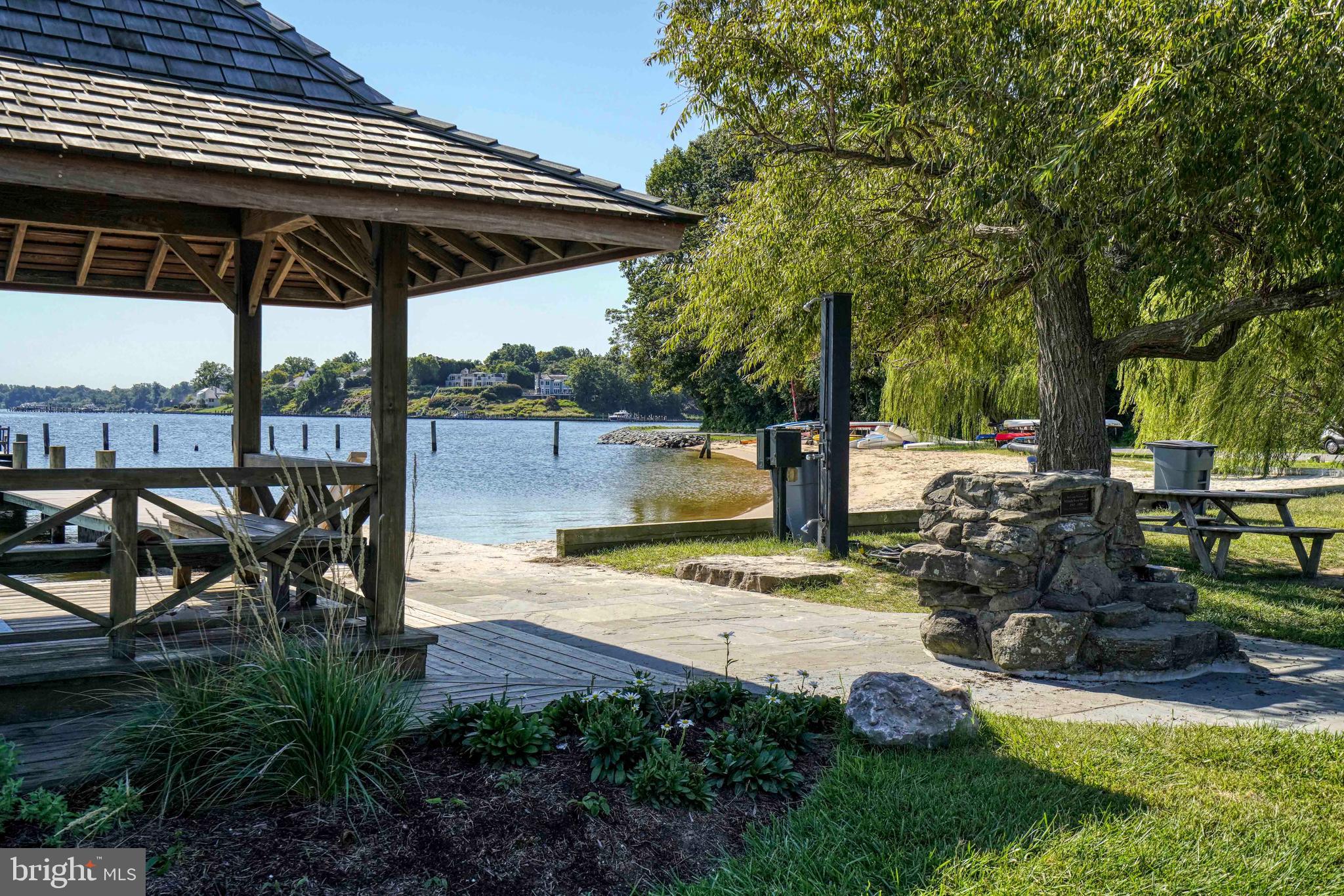 769 Robin Hood Road Annapolis, MD 21405 - Photo 56 of 79 a view of a patio with table and chairs under an umbrella