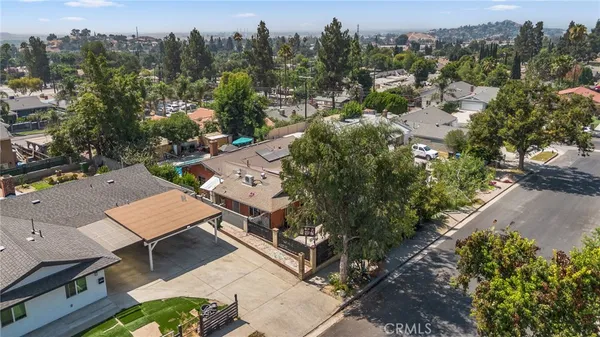 an aerial view of residential houses with outdoor space