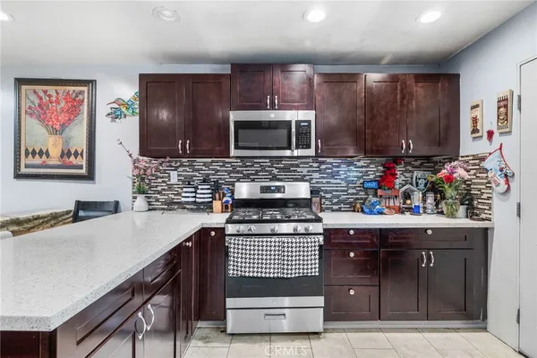 a kitchen with a sink stove and microwave