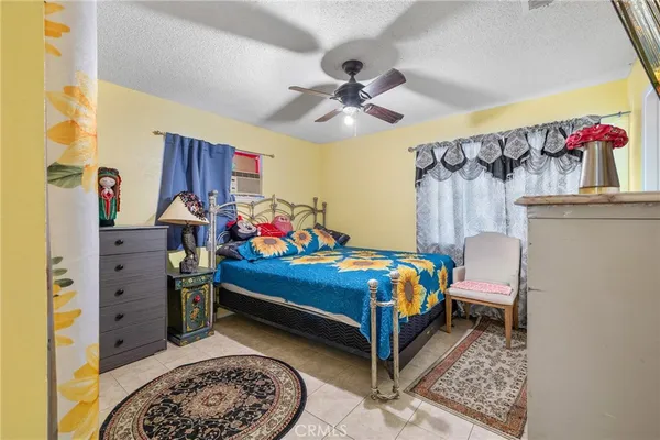 a bedroom with a bed and a painting on the wall