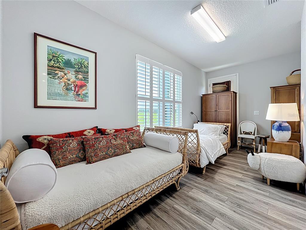 10220 Bay Lake Road Groveland, FL 34736 - Photo 25 of 67 a bedroom with bed couch and window