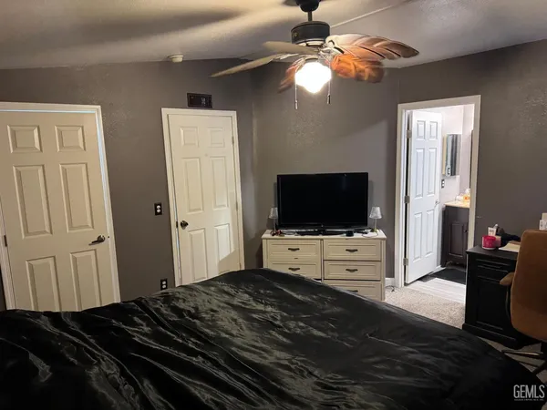 a bedroom with furniture and flat screen tv