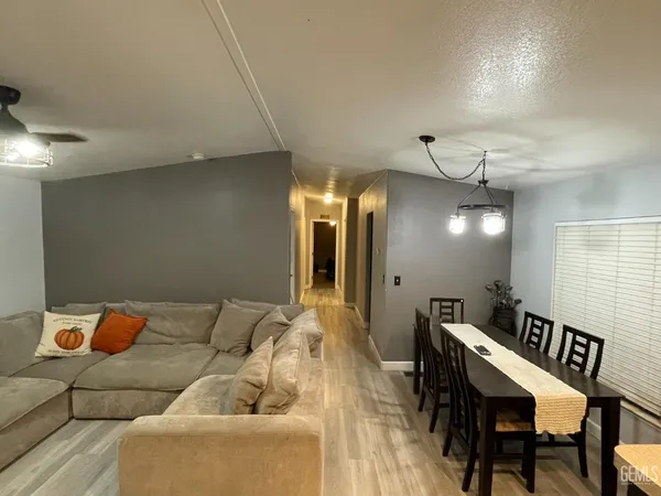 a dining room with furniture and a chandelier
