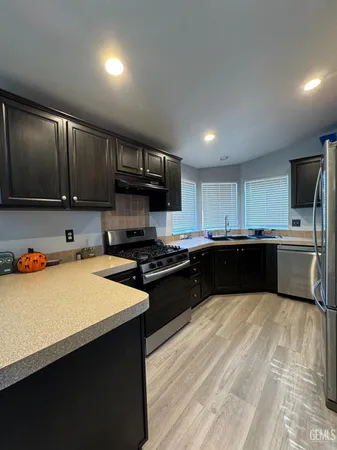a kitchen with a sink a stove and cabinets