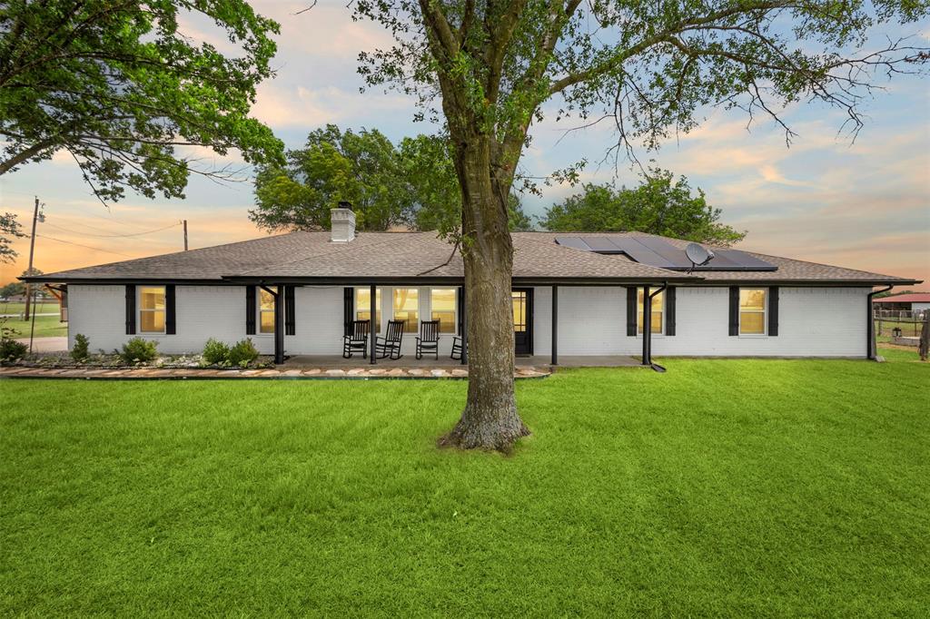 6754 Raymond Road Kaufman, TX 75142 - Photo 1 of 38 Ranch-style exterior with white siding, a dark roof, and black window shutters
