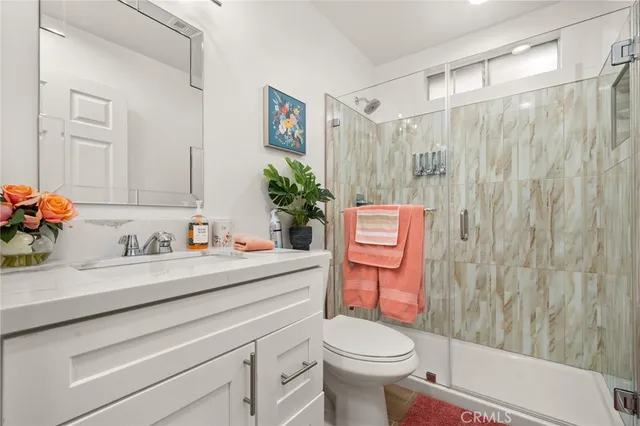 a bathroom with a sink a toilet and a shower