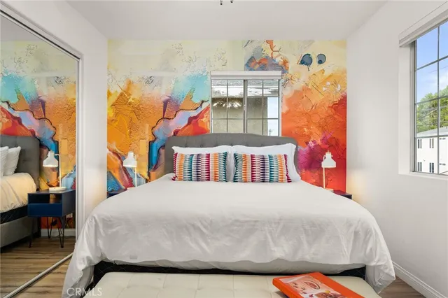 a bedroom with a bed and a window