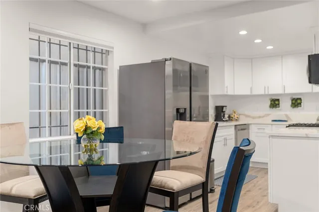 a dining room filled chandelier and kitchen view
