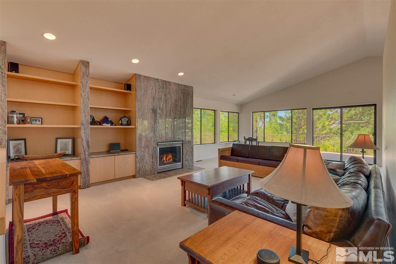 12935 Roseview Lane Reno, NV 89511 - Photo 2 of 17 a living room with furniture a fireplace and a table