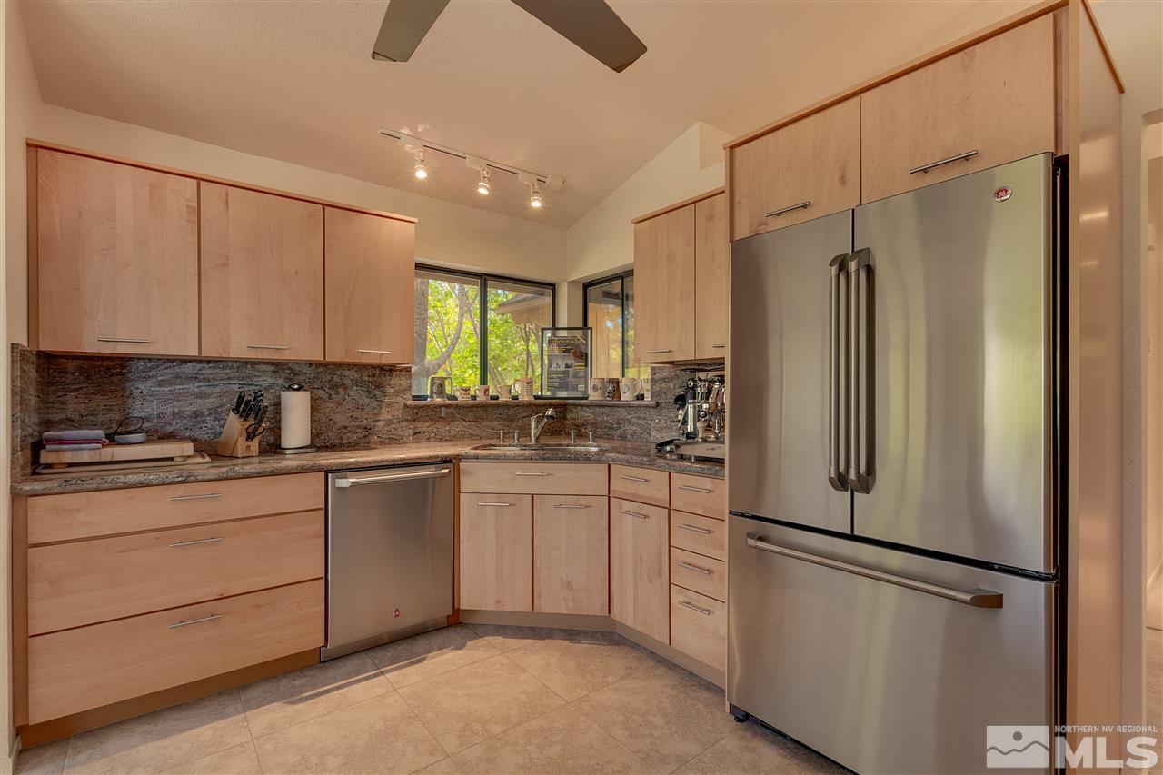 12935 Roseview Lane Reno, NV 89511 - Photo 7 of 17 a kitchen with stainless steel appliances a refrigerator sink and cabinets