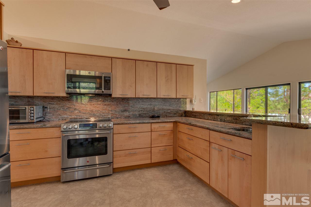 12935 Roseview Lane Reno, NV 89511 - Photo 8 of 17 a kitchen with stainless steel appliances granite countertop a stove and a sink