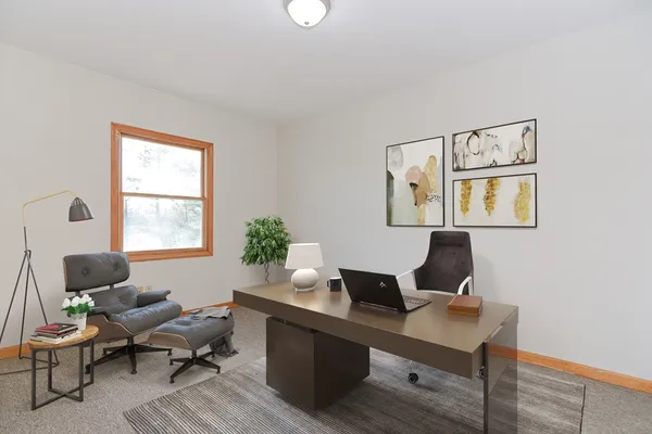 a workspace with furniture and a window
