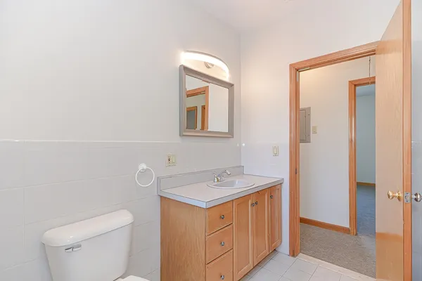a bathroom with a sink a toilet and mirror