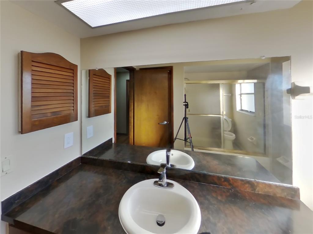 Undisclosed Address Spring Hill, FL 34608 - Photo 11 of 16 a bathroom with a sink and a mirror