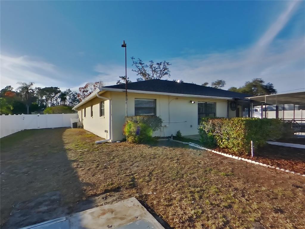 Undisclosed Address Spring Hill, FL 34608 - Photo 15 of 16 front view of a house with a yard