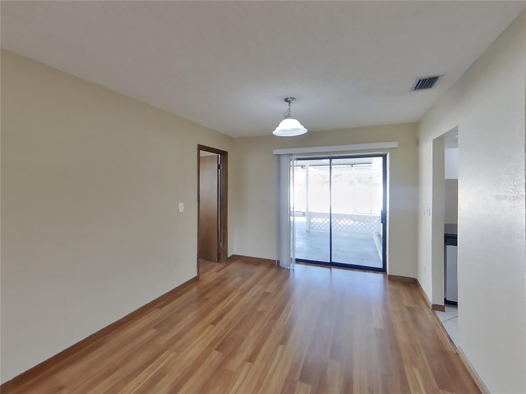Undisclosed Address Spring Hill, FL 34608 - Photo 3 of 16 a view of empty room with wooden floor and fan