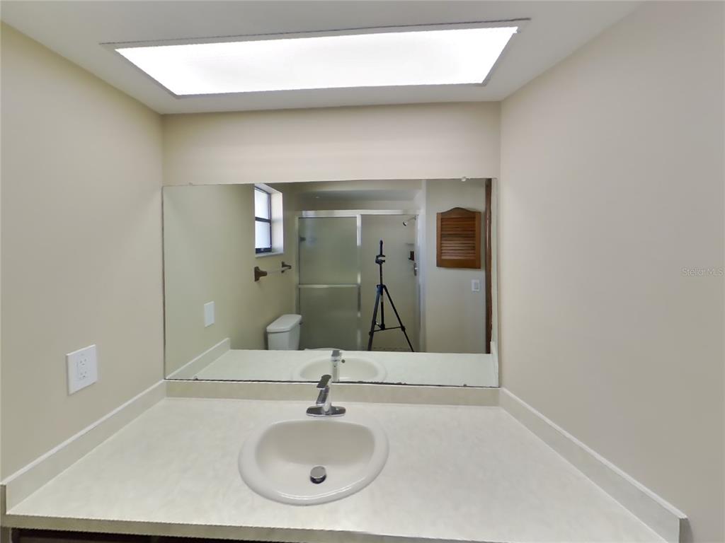 Undisclosed Address Spring Hill, FL 34608 - Photo 7 of 16 a bathroom with a sink and a mirror