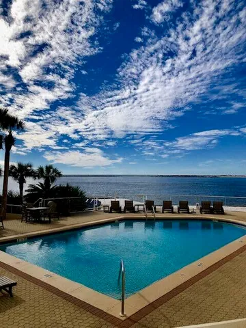 a view of swimming pool with outdoor seating