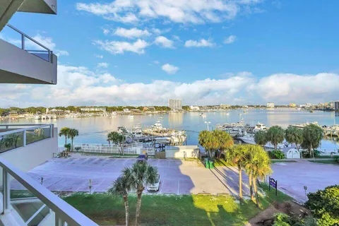 a view of a lake with lawn chairs