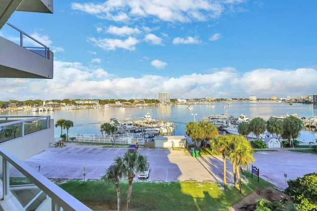 a view of a lake with lawn chairs