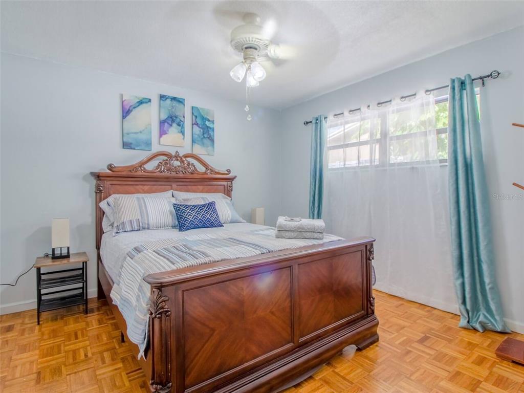 Undisclosed Address Orlando, FL 32812 - Photo 11 of 26 a bedroom with a bed and a chandelier