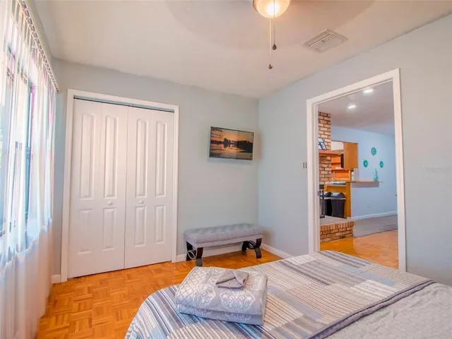 a bedroom with a bed and a painting on the wall