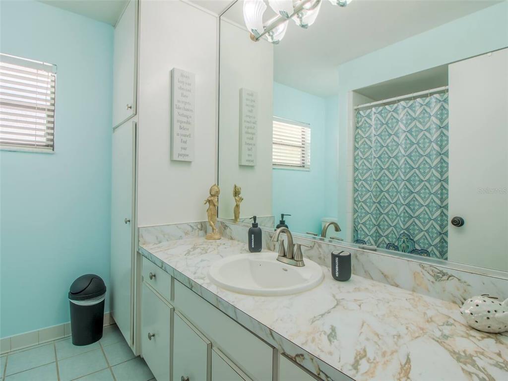 Undisclosed Address Orlando, FL 32812 - Photo 15 of 26 a bathroom with a granite countertop sink a toilet and a mirror