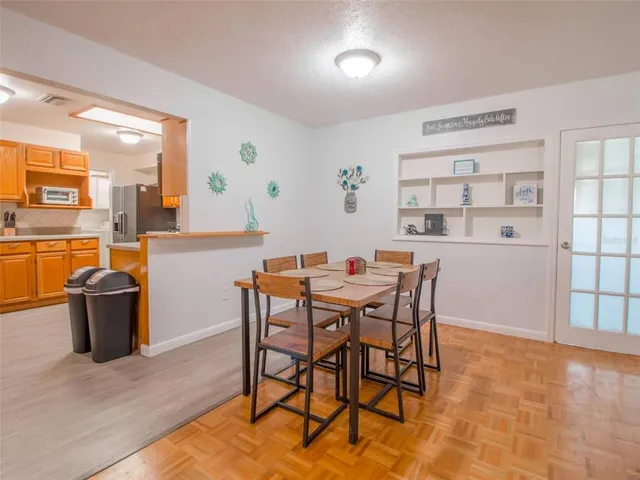 a dining room with a wooden table and chairs