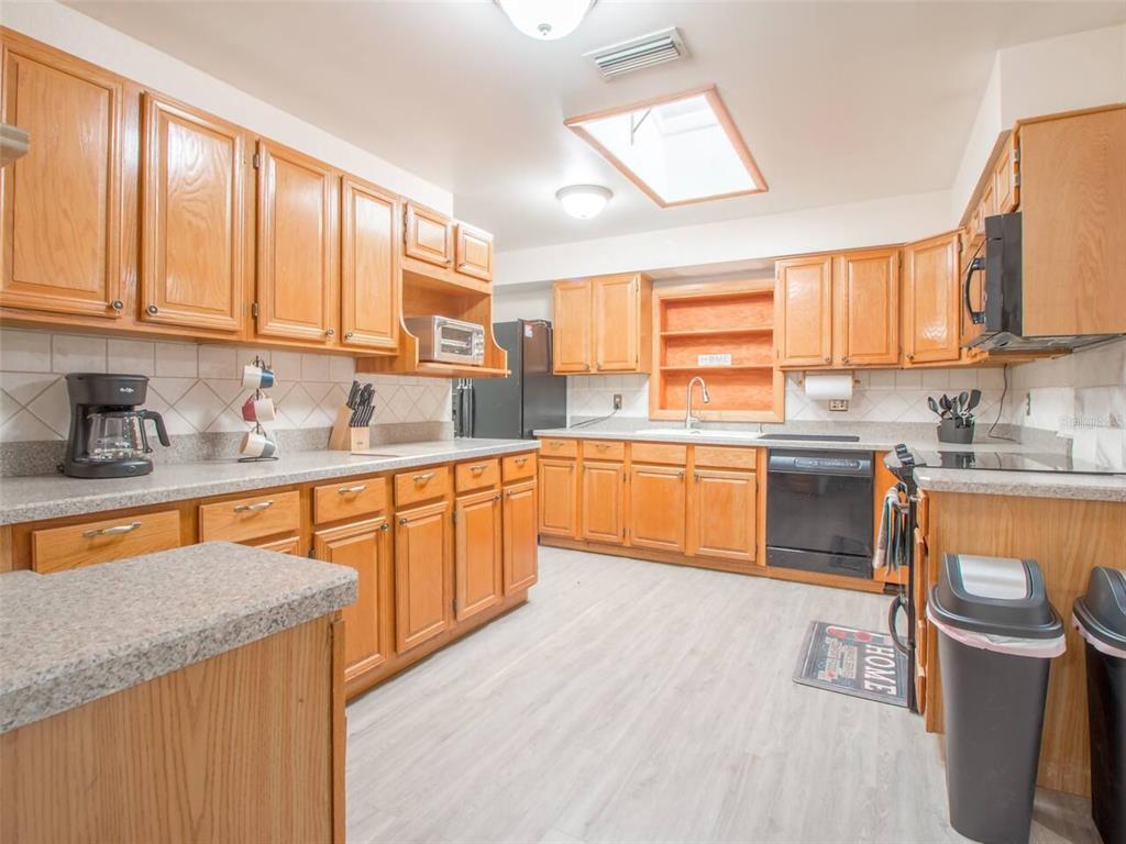 Undisclosed Address Orlando, FL 32812 - Photo 7 of 26 a kitchen with stainless steel appliances granite countertop wooden cabinets a sink and a stove