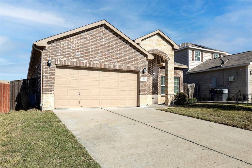 14247 Greenhaw Lane Dallas, TX 75253 - Photo 2 of 39 a front view of a house with a yard and garage