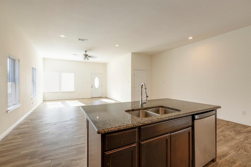 14247 Greenhaw Lane Dallas, TX 75253 - Photo 39 of 39 a kitchen with a sink cabinets and wooden floor