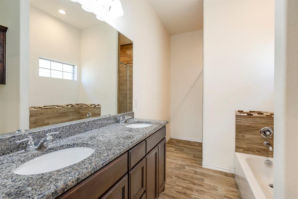 14247 Greenhaw Lane Dallas, TX 75253 - Photo 33 of 39 a bathroom with a granite countertop sink and a mirror