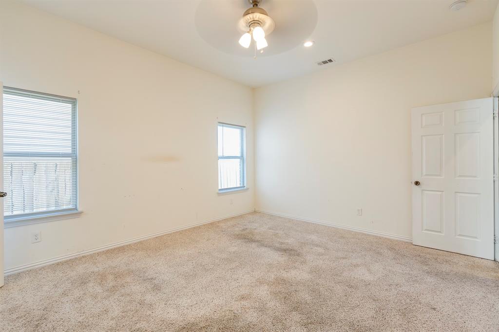 14247 Greenhaw Lane Dallas, TX 75253 - Photo 9 of 39 an empty room with windows and chandelier fan