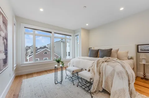 a bedroom with furniture and a window