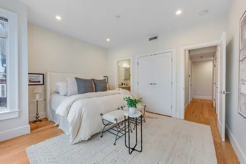 a bedroom with a bed and a table in it