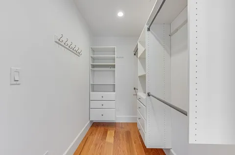 a view of walk in closet with empty racks