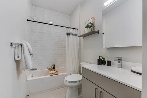 a bathroom with a sink a toilet and shower curtain