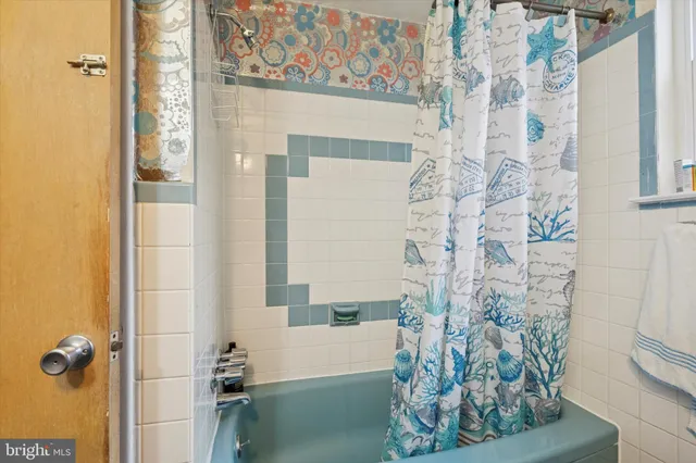 a bathroom with a bathtub and shower