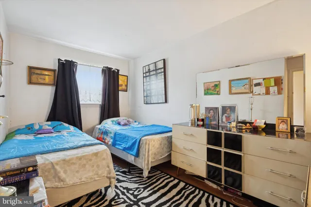 a bedroom with two beds and a dresser