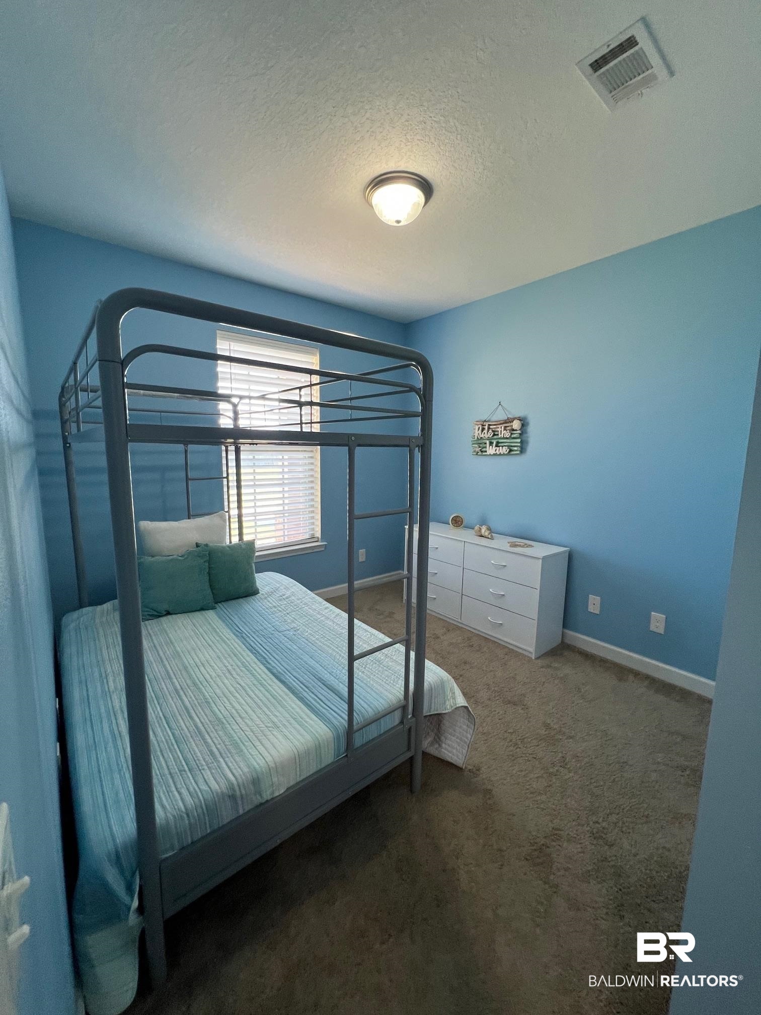 10257 Lyttleton Loop Lillian, AL 36549 - Photo 21 of 31 Bedroom featuring a textured ceiling and dark carpet
