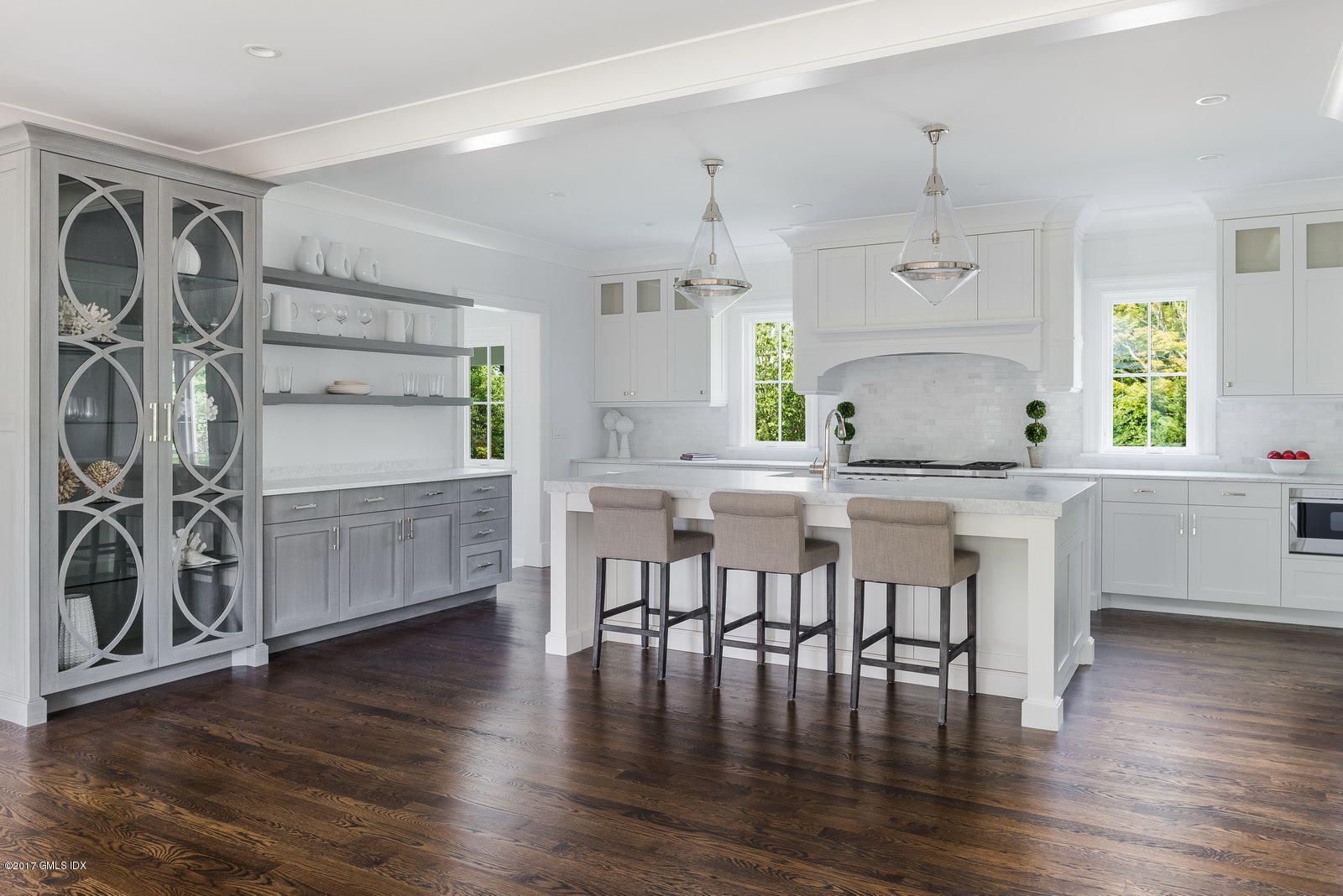 12 Ballwood Road Old Greenwich, CT 06870 - Photo 5 of 25 a kitchen with stainless steel appliances a dining table chairs and wooden floor