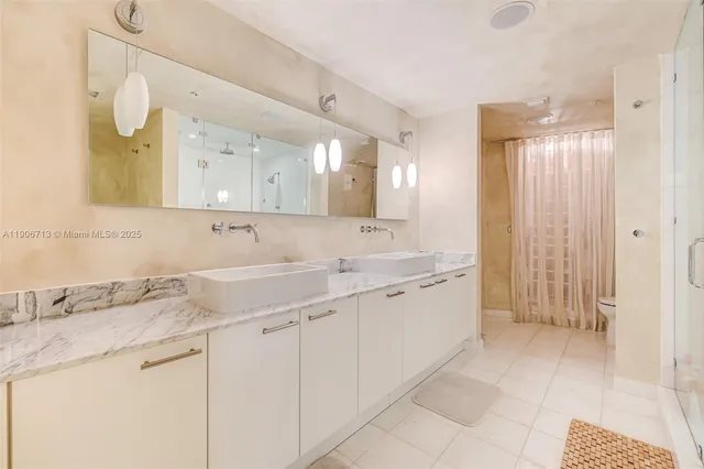 a spacious bathroom with a granite countertop sink and a mirror