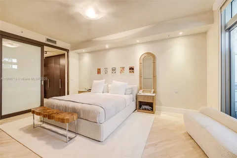 a spacious bedroom with a bed and a window