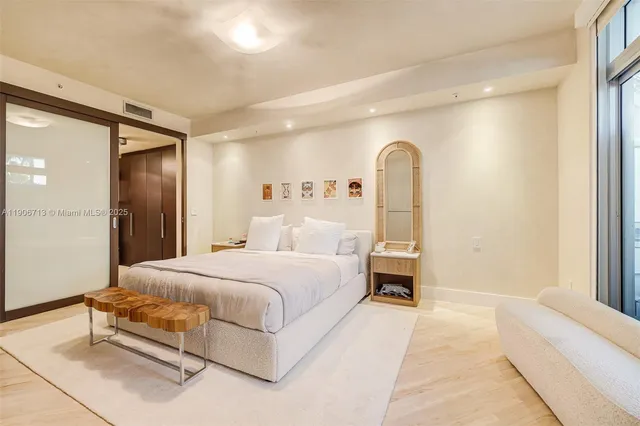 a spacious bedroom with a bed and a window