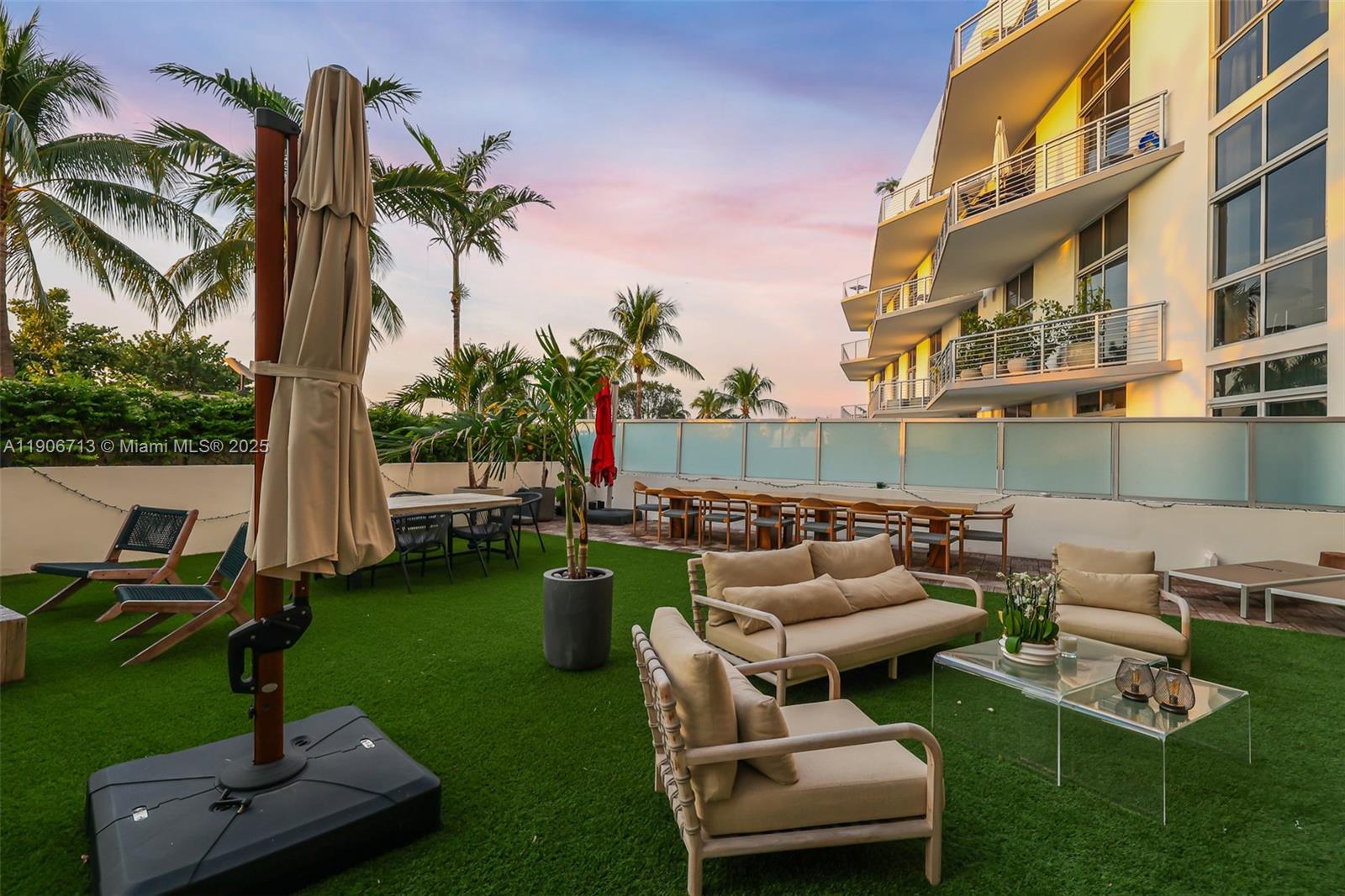 2001 Meridian Avenue, Unit 307 Miami Beach, FL 33139 - Photo 20 of 25 a view of a backyard with couches table and chairs and potted plants