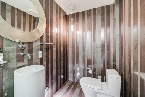 a bathroom with a toilet a sink and bathtub