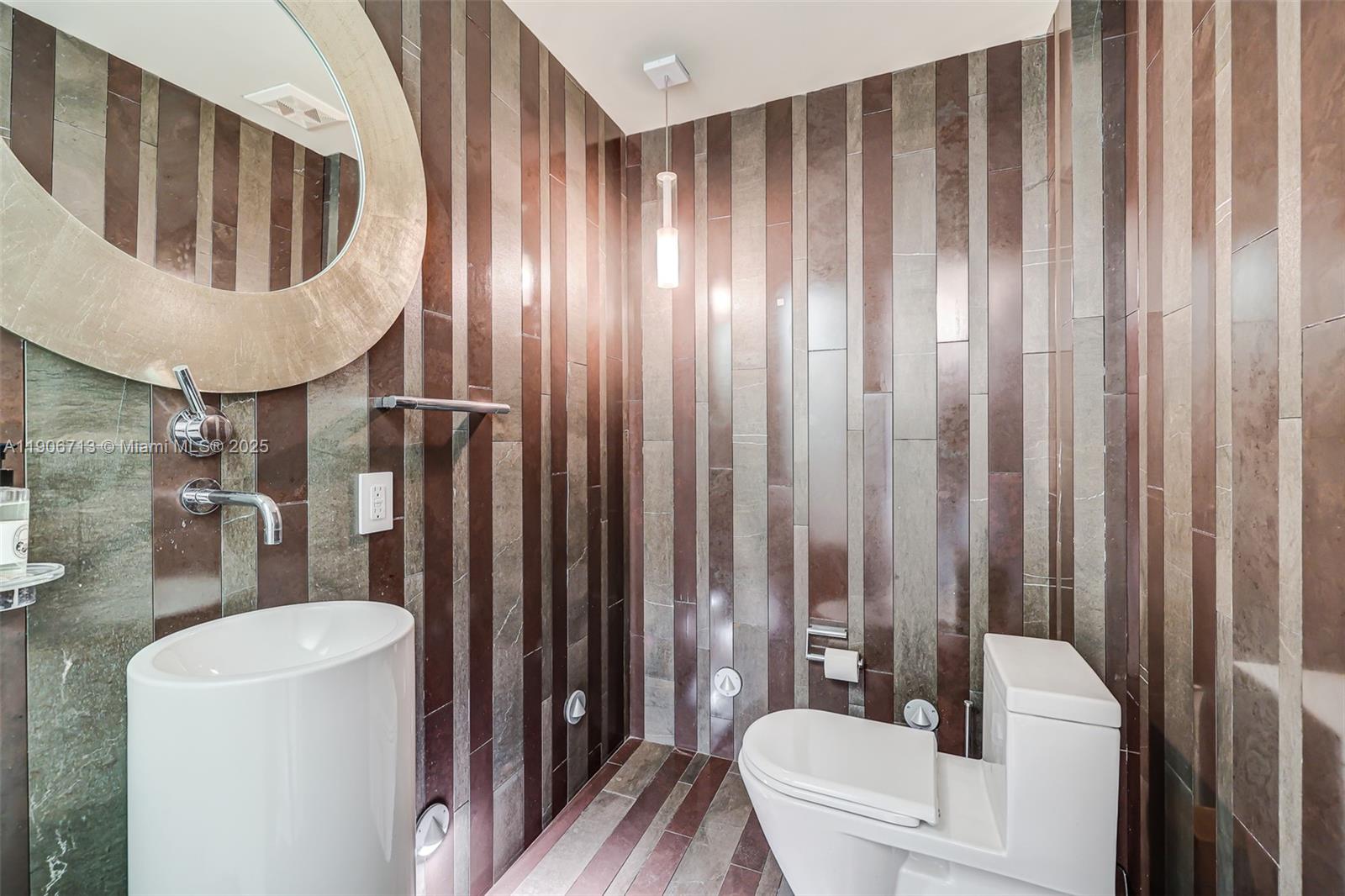 2001 Meridian Avenue, Unit 307 Miami Beach, FL 33139 - Photo 21 of 25 a bathroom with a toilet a sink and bathtub